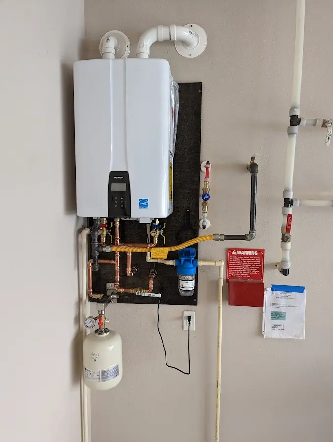 Professional plumber installing copper piping in a Hudson Falls home